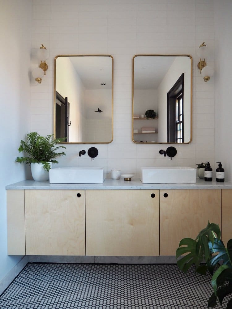 His and hers bathroom sinks with cupboards beneath and two large rectangular mirrors