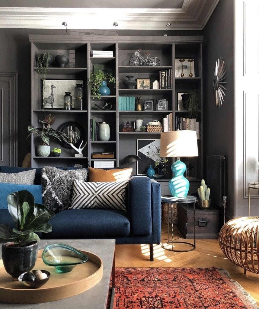 Blue sofa in front of dark grey painted bookcase